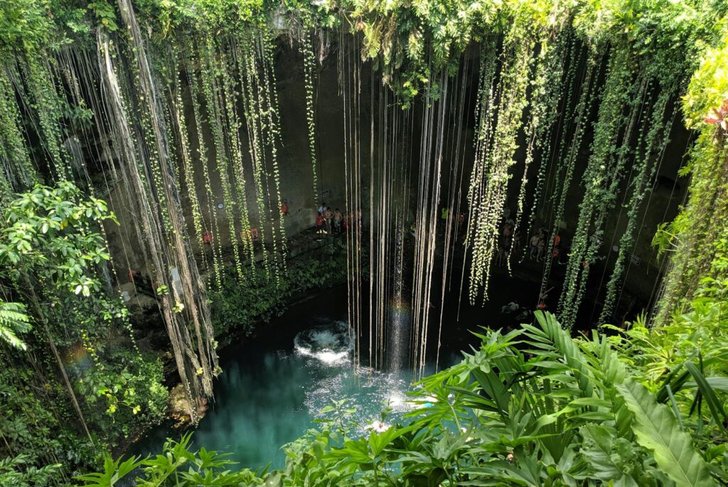 Beautiful view of Cenote Ik Kil surrounded by lush greenery in Yucatan, Mexico.